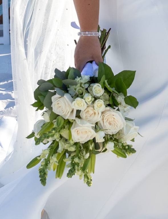 Bride holding a white rose bouquet on Anna Maria Island