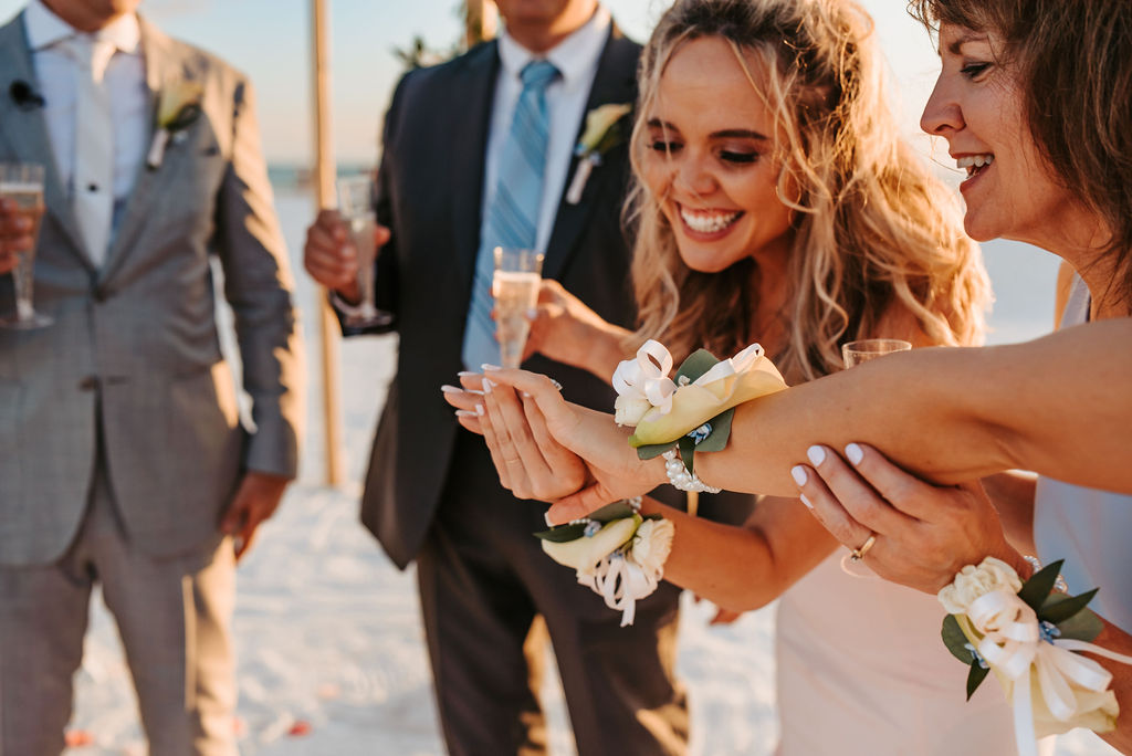 Guests toasting with bubbly and corsages at Nokomis Beach